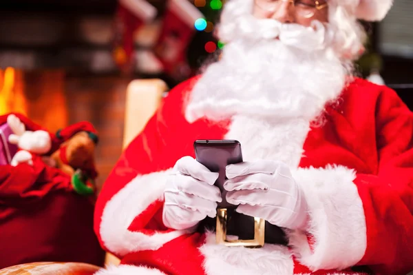 Санта-Клауса, ввівши повідомлення на мобільний телефон — стокове фото