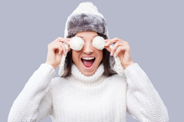 Woman holding pompons of hat in front of eyes — Stock Photo, Image