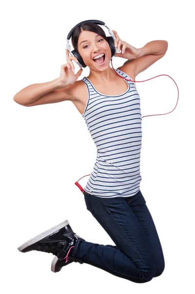 Woman in headphones jumping — Stock Photo, Image
