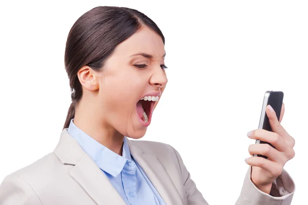 Businesswoman holding mobile phone and screaming — Stock Photo, Image