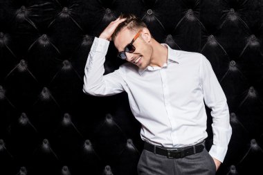Genç adam elini tutarak saç Beyaz gömlekli