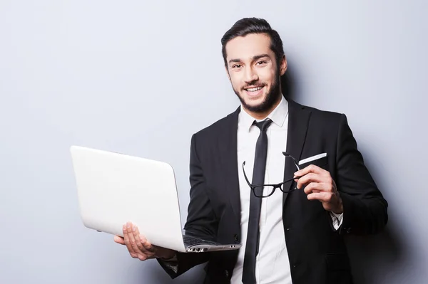Man in formalwear holding laptop — Stock Photo, Image