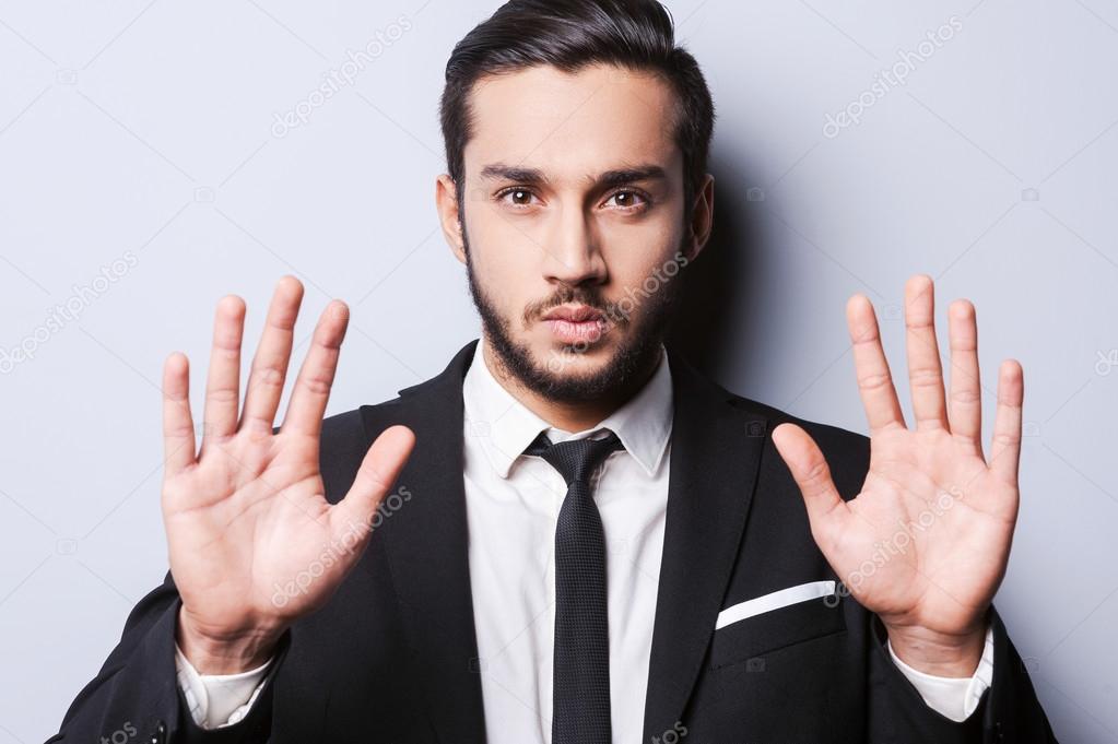 Man in formalwear showing his palms