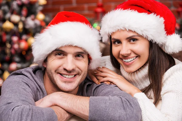 Loving couple in Santa hats Stock Picture