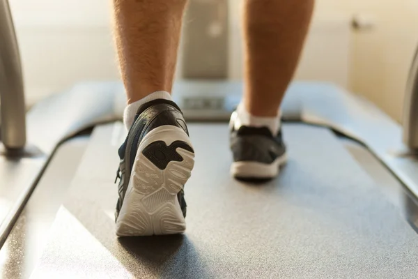 Man walking by treadmill in sports club — Stock Photo, Image