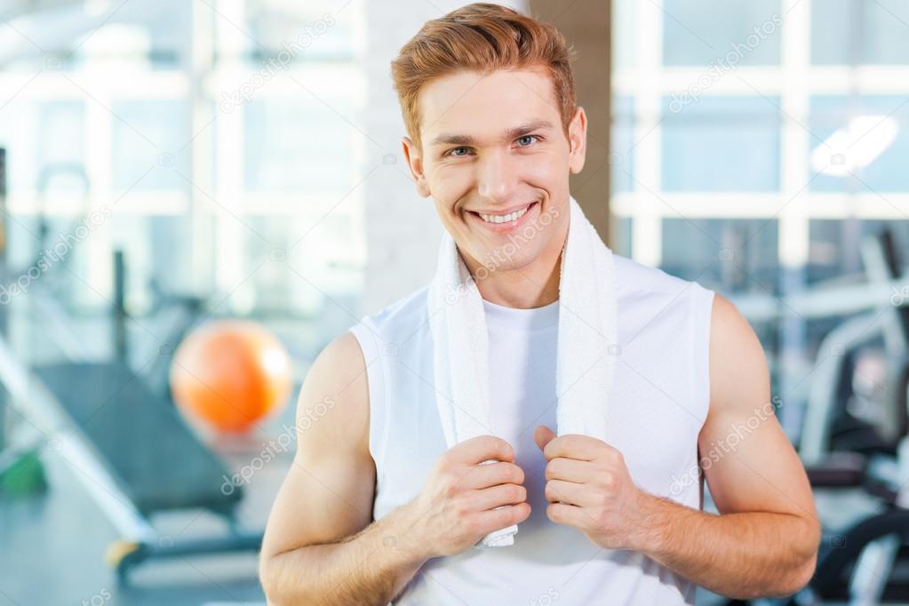 Muscular man carrying towel on shoulders