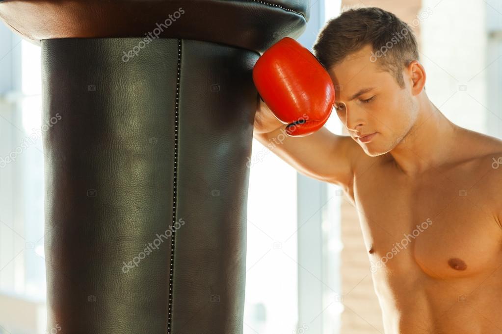 Boxer  leaning at the punching bag