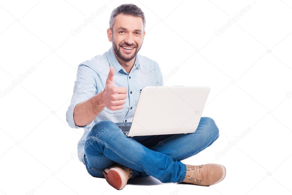 Man  sitting on the floor with laptop