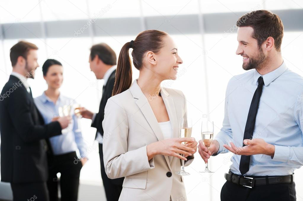 Cheerful business people drinking champagne