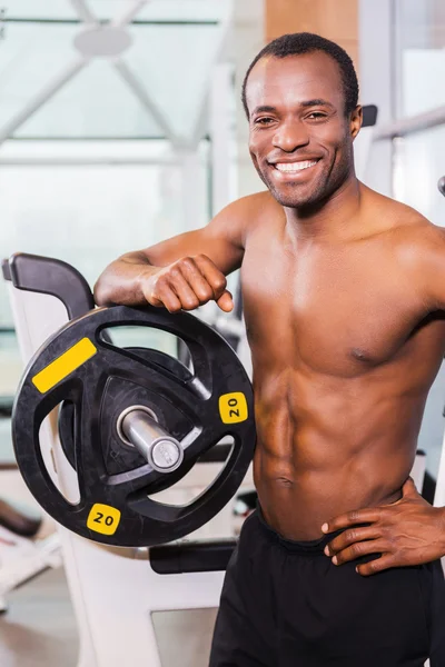 Afrikansk man i gym nära bänkpress — Stockfoto