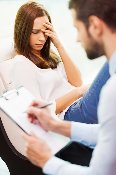 Depressed woman and man writing in clipboard — Stock Photo, Image