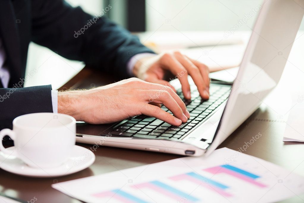 Man in formalwear working on laptop