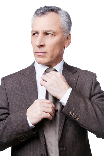 Mature man in formalwear adjusting his necktie — Stock Photo, Image