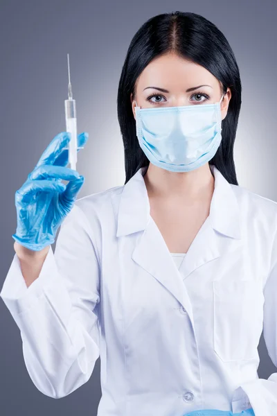 Female doctor holding syringe — Stock Photo, Image