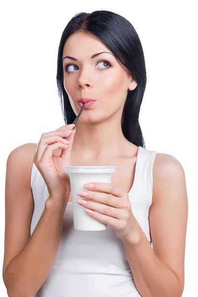 Woman licking spoon with sour cream — Stock Photo, Image