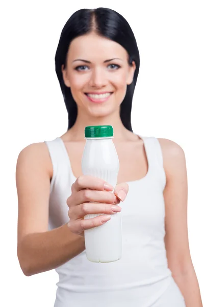 Woman stretching out white bottle — Stock Photo, Image