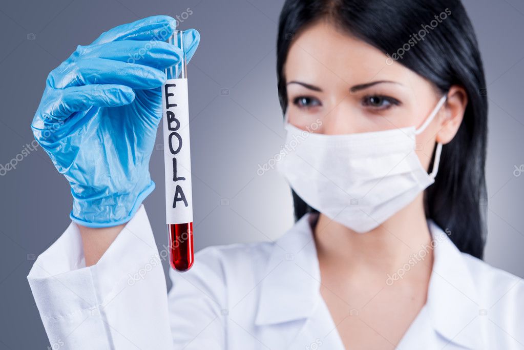 Female doctor  holding flask with blood