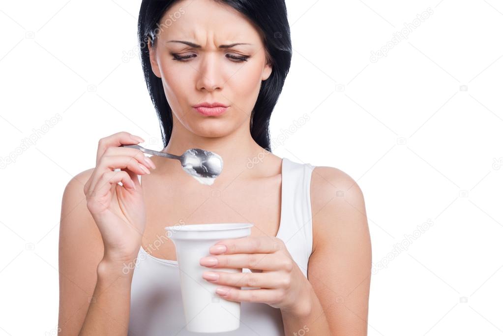 Woman holding  spoon with sour cream