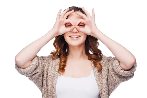 Smiling woman holding fingers near eyes — Stock Photo, Image