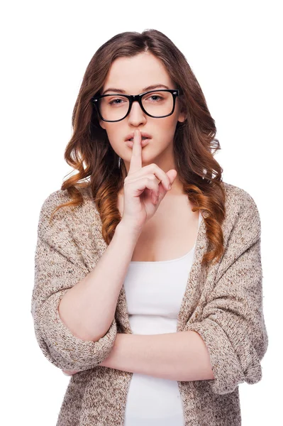 Woman in eyeglasses holding finger on lips — Stock Photo, Image