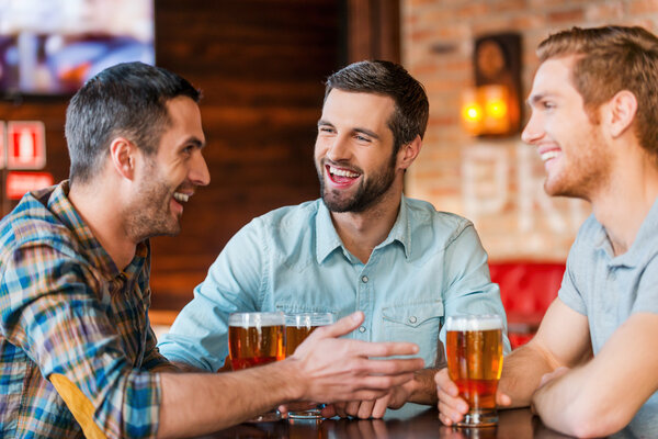 Young men  talking and drinking beer
