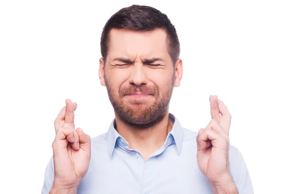 Man in shirt keeping fingers crossed — Stock Photo, Image