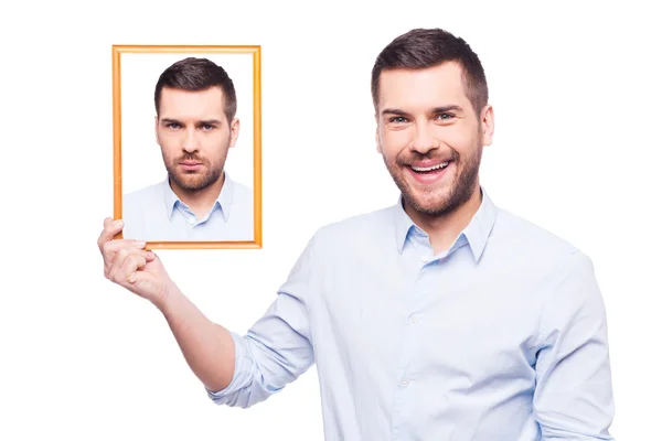 Man in shirt holding upset picture of himself — Stock Photo, Image