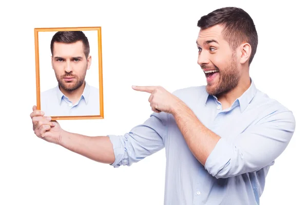 Man in shirt holding upset picture of himself — Stock Photo, Image