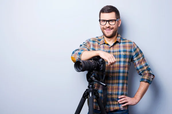 Мужчина в рубашке держит руку на камере — стоковое фото
