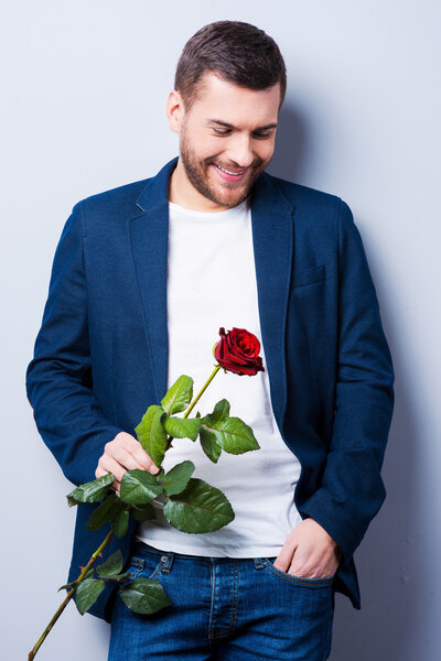 Handsome young man holding flower