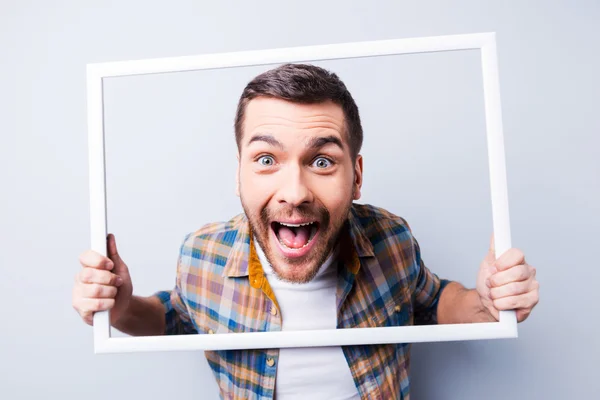 Man in shirt holding picture frame — Stock Photo, Image