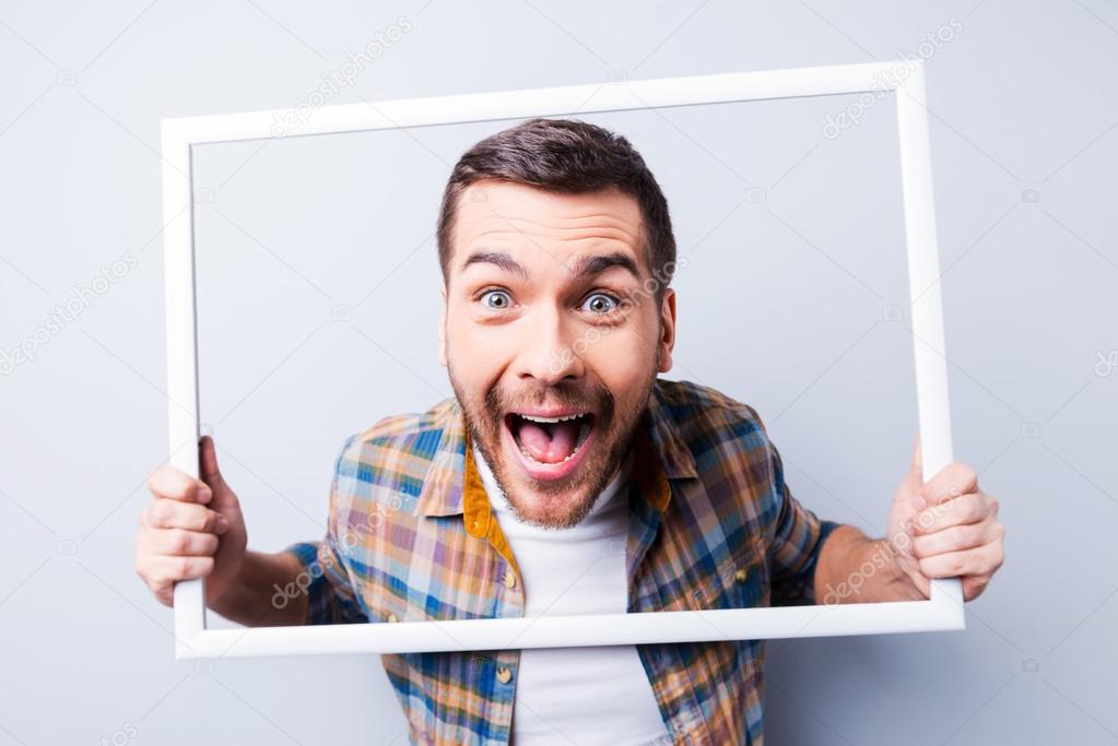 Man in shirt holding picture frame