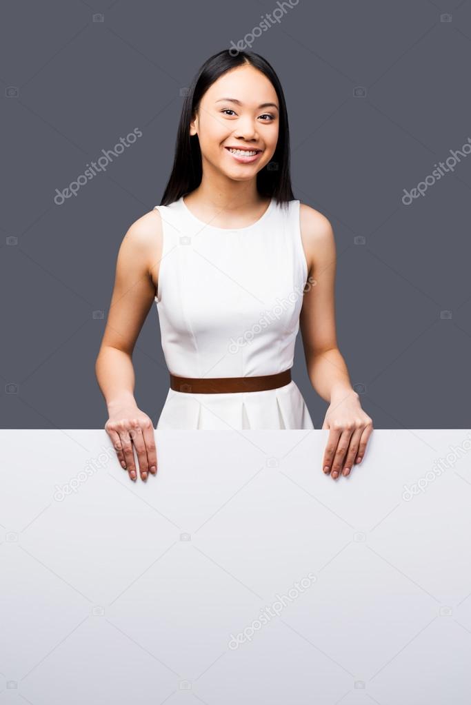 Asian woman holding copy space