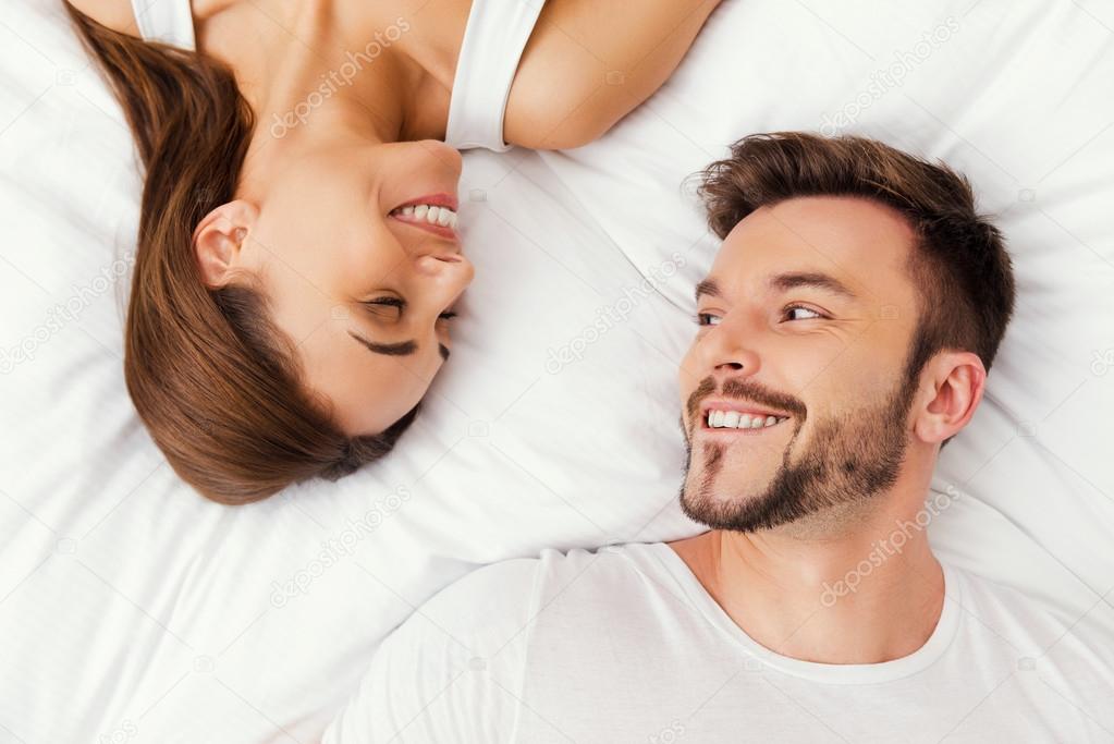 Loving couple lying in bed