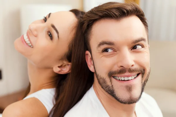 Couple sitting back to back — Stock Photo, Image