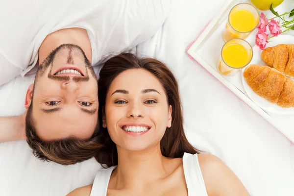 Loving couple lying in bed — Stock Photo, Image