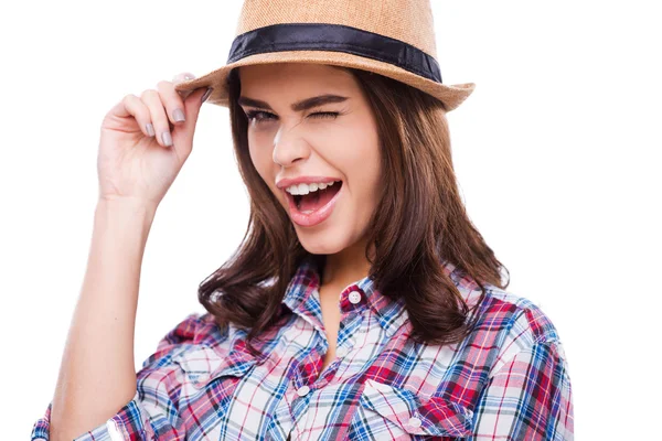 Woman adjusting hat and winking — Stock Photo, Image