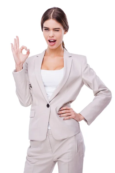 Woman winking and gesturing ok — Stock Photo, Image