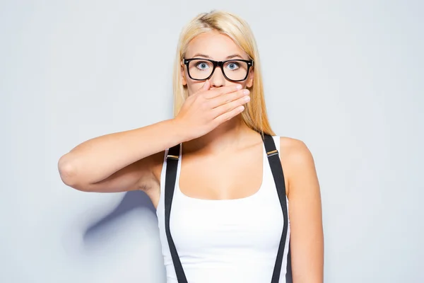 Woman covering mouth with hand — Stock Photo, Image