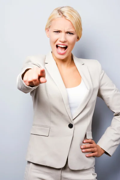 Furious young businesswoman pointing you — Stock Photo, Image