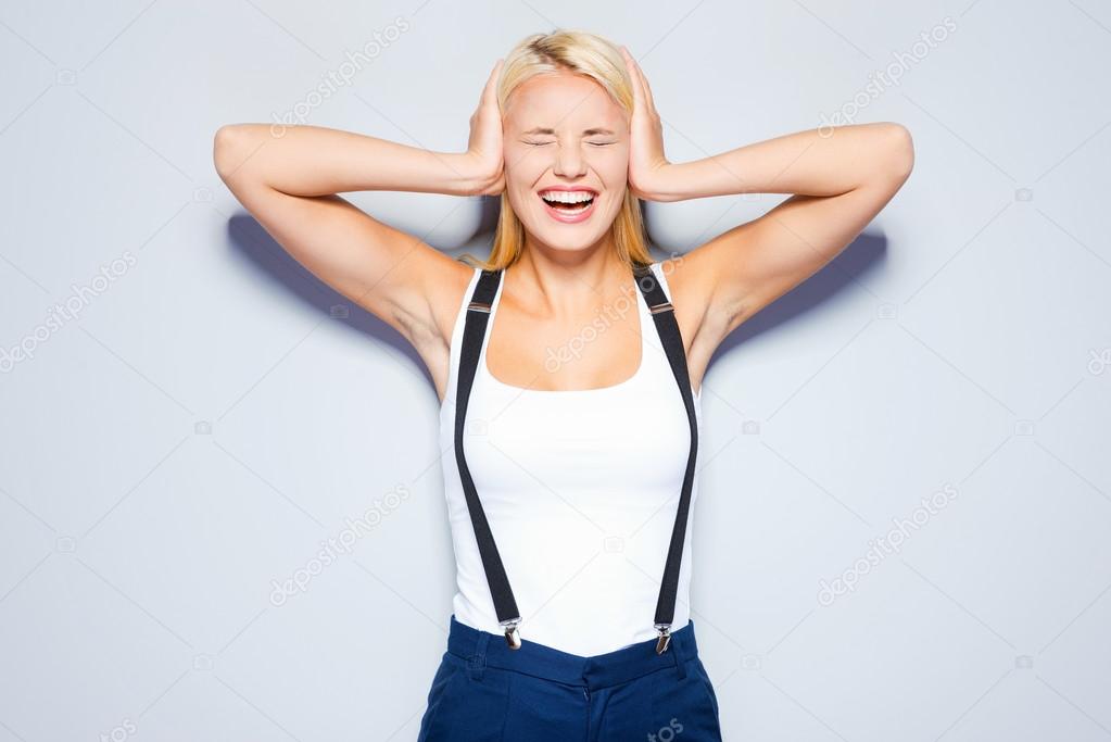Woman covering ears with hands