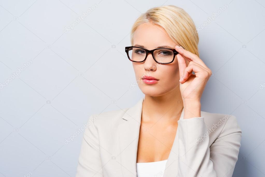 Businesswoman adjusting her eyewear