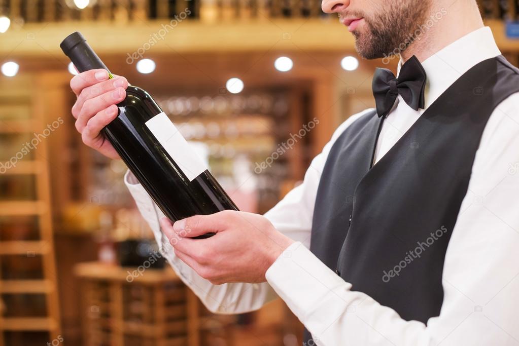 Man examining wine bottle