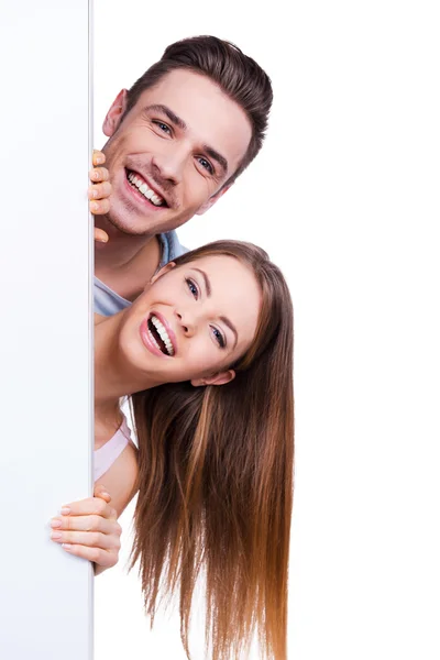 Loving couple peeking out copy space — Stock Photo, Image