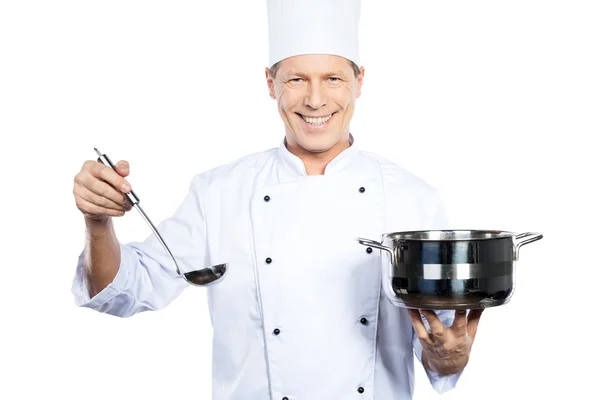 Chef holding casserole and scoop — Stock Photo, Image