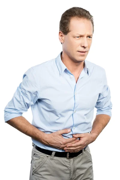 Mature man touching his stomach — Stock Photo, Image