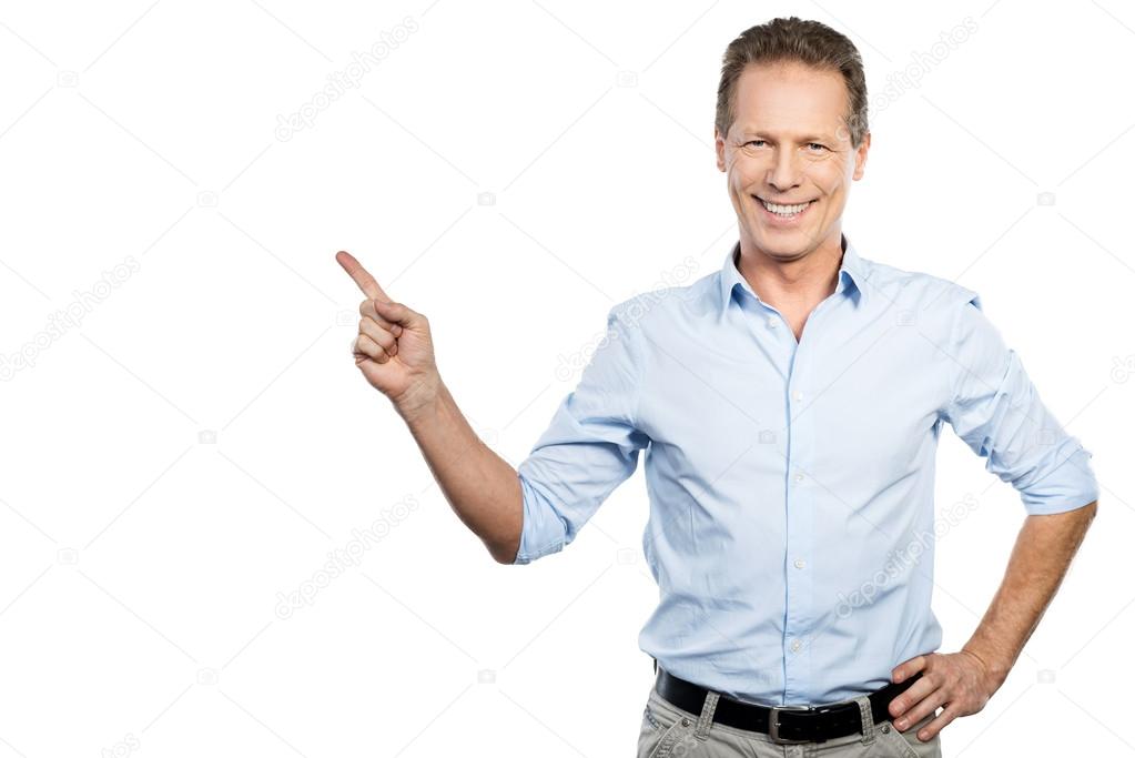 Mature man in shirt  pointing away