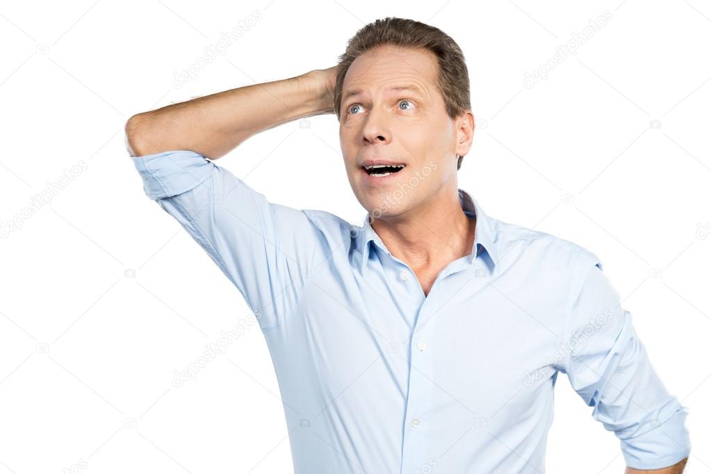 Excited mature man touching head