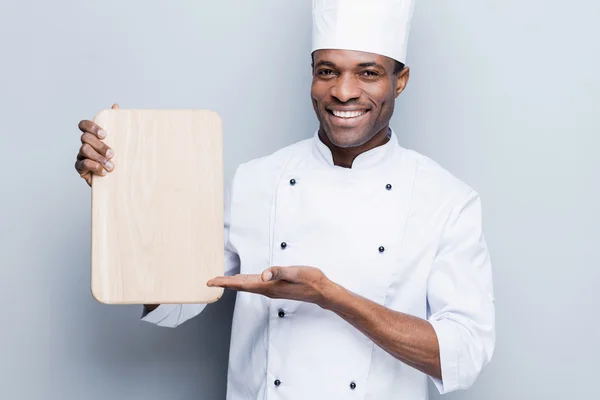Chef africano sosteniendo tabla de cortar — Foto de Stock
