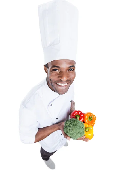 African chef holding vegetables — Stock Photo, Image